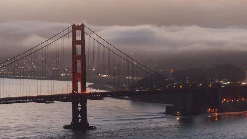 View of a bridge in a big city with lots of traffic