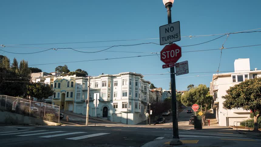 Traffic and pedestrians travel through the intersection