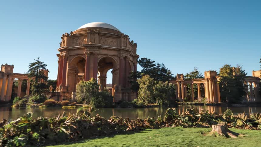Tourists are visiting a landmark on a sunny day