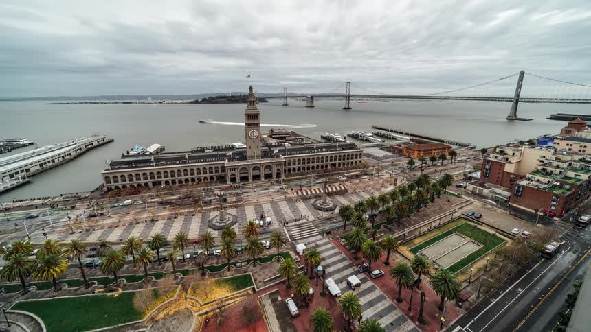 View of a city with a harbor and a bridge