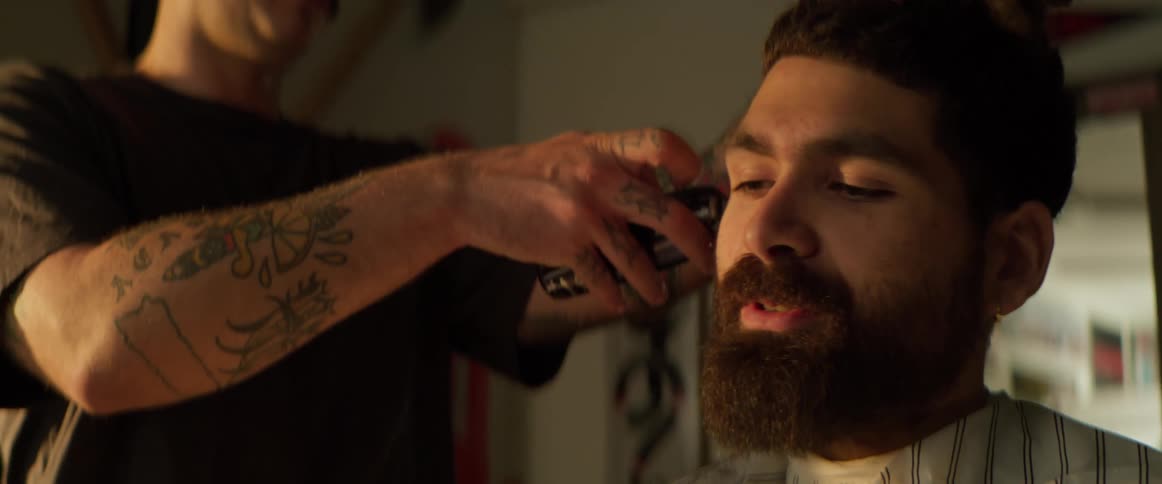 Boy whose hair is cut off with a razor