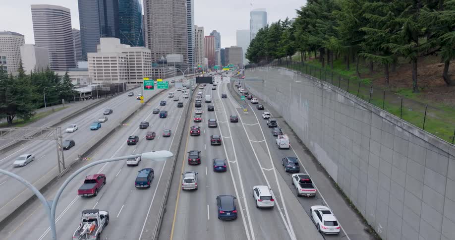 Traffic starts to backup along a multilane expressway as communters head into downtown to start work