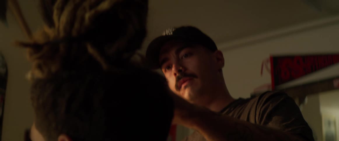 A barber holds his customers head