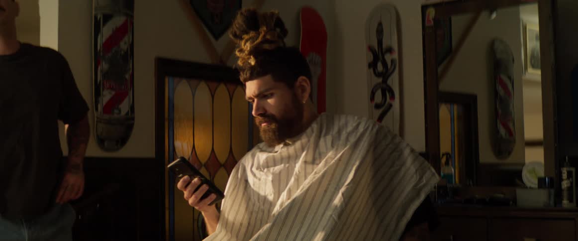A barber is talking with a customer