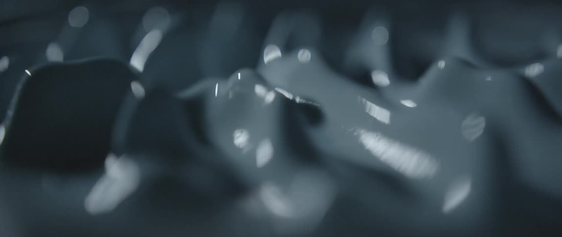A milky, gray liquid is bouncing up and down