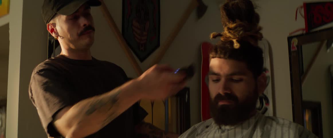 Boy cutting a tall boys hair with a razor