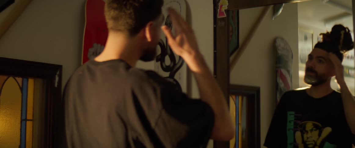 A man checks his haircut and shave in the barbershop