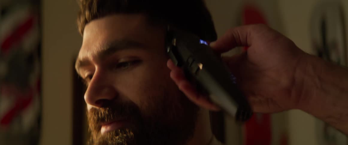 A man chats while getting a haircut