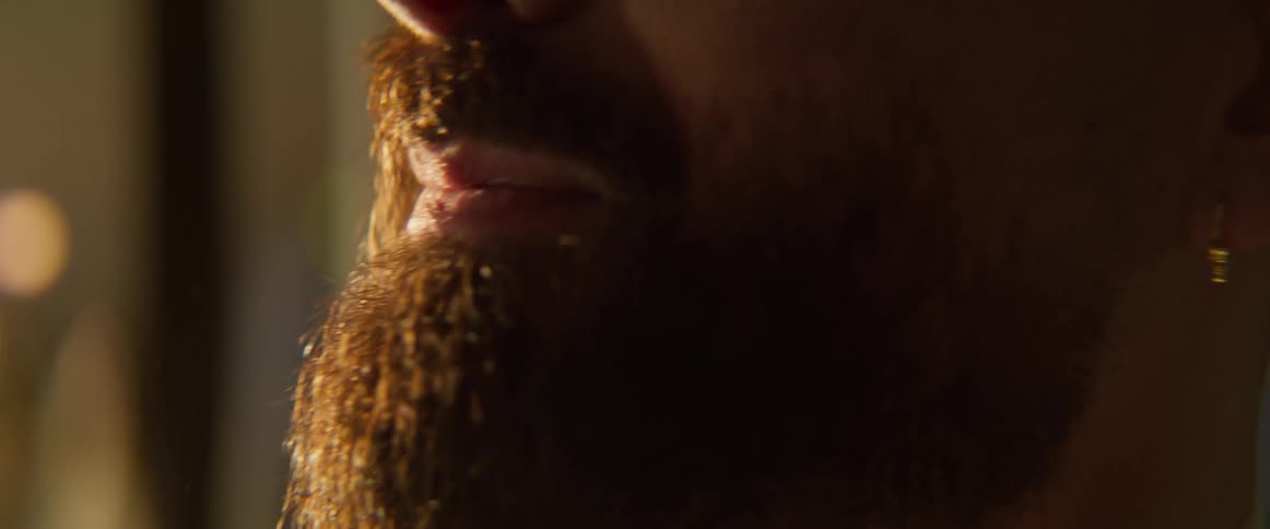 A man wipes his beard