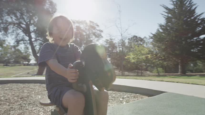 Child rides a playground toy