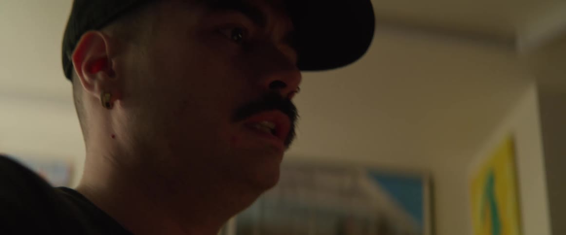 A man with a mustache is talking