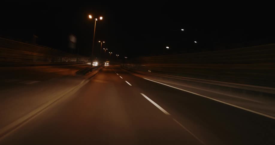 Cars drive into the tunnel at night on the highway