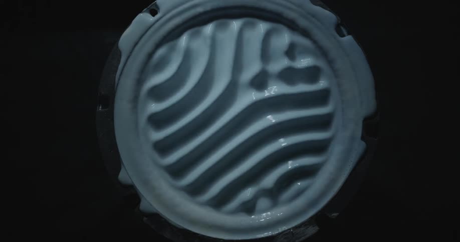 A speaker filled with paint vibrates to create ripples