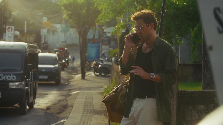 A man is talking on his cell phone in the city