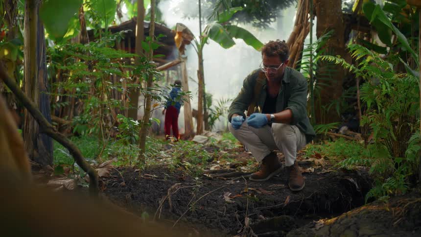 A scientist preparing a water sample in the jungle