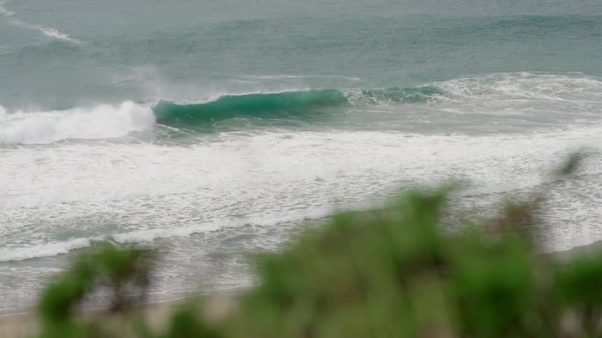 A large wave breaking at the ocean shore