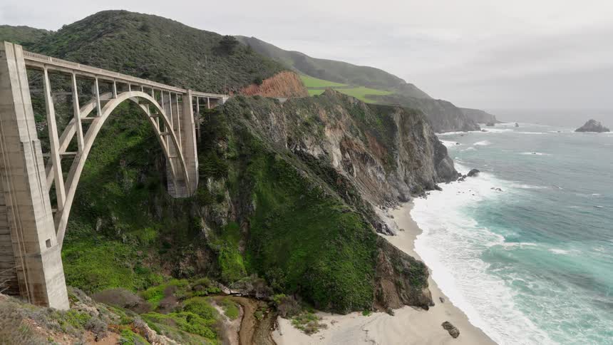 A bridge is on the mountain by the beach