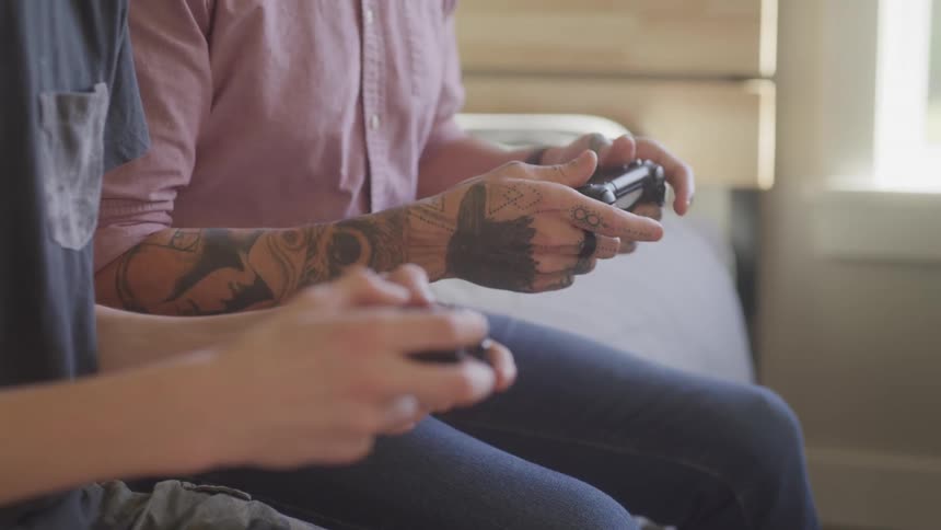 Two men are playing videogames together