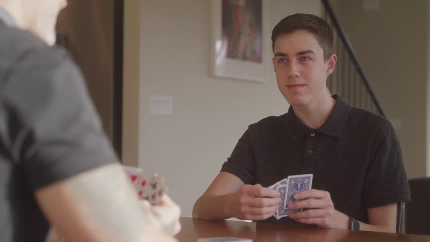 People are playing a game of cards