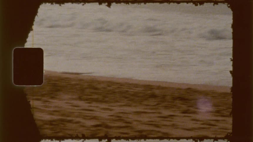 A clip of a boy coming out of the sea wave