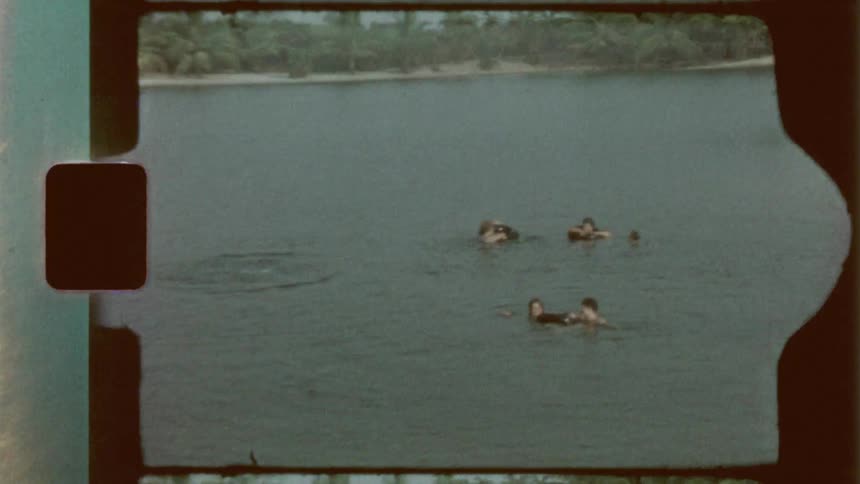 Teenagers float on inner tubes in the water