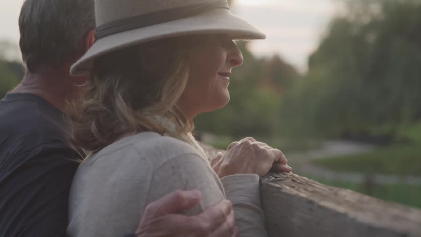 A couple smile while looking at nature together