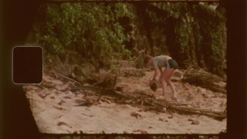 A child throws a coconut trying to open it