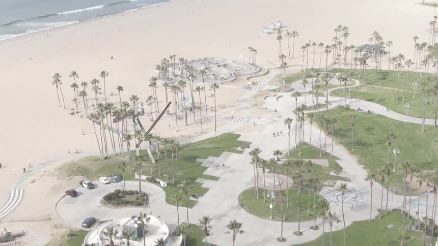 People are walking on the boardwalk by the beach