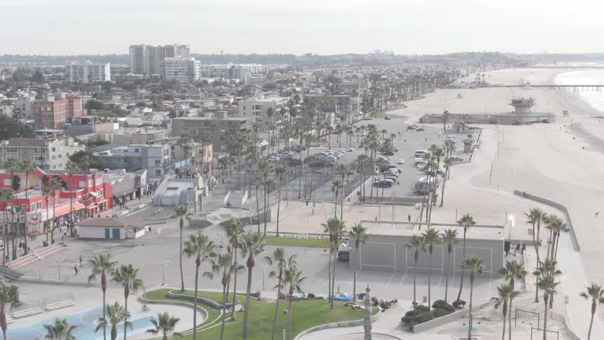 Buildings and parking lots are right on a beach of a coastal area