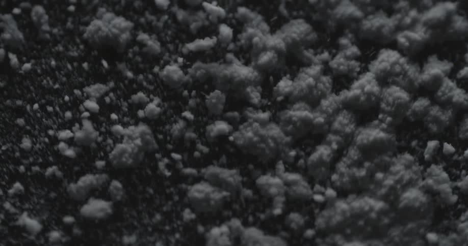 Particles of something vibrating and bouncing into the air from the vibration below it