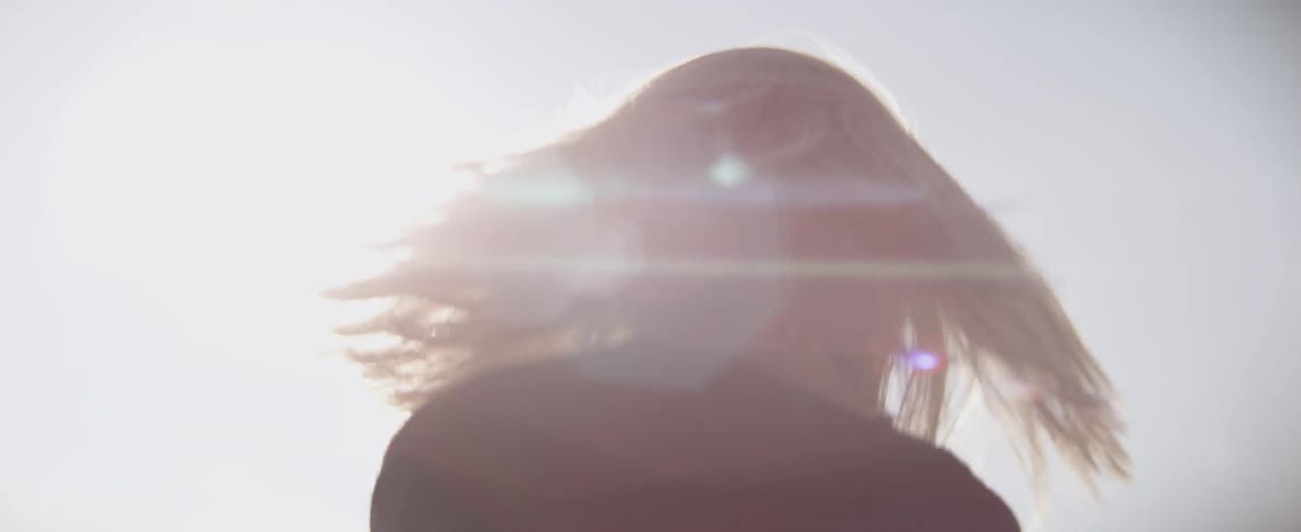 A woman whips around with her hair moving in a circle