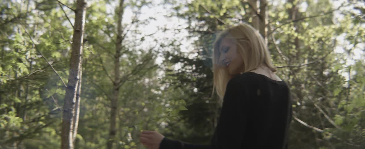 A woman walks through the forest