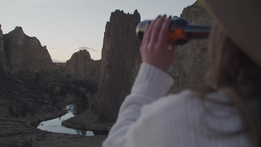 A woman drinks beer outside