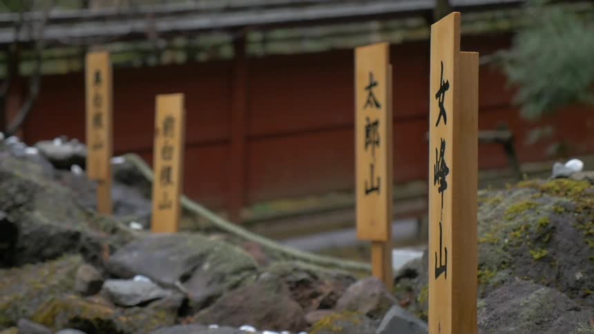 A close up of some rocks with little wooden signs in them