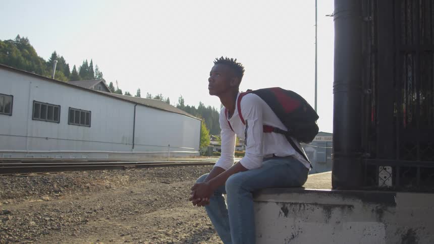 Boy sitting in a little wall