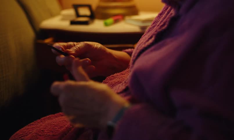 A footage of an elderly lady making up