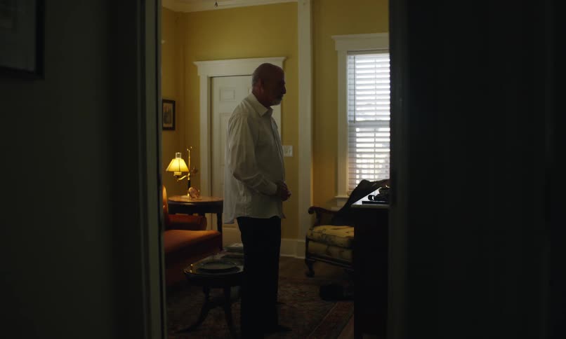 A man is buttoning up his shirt