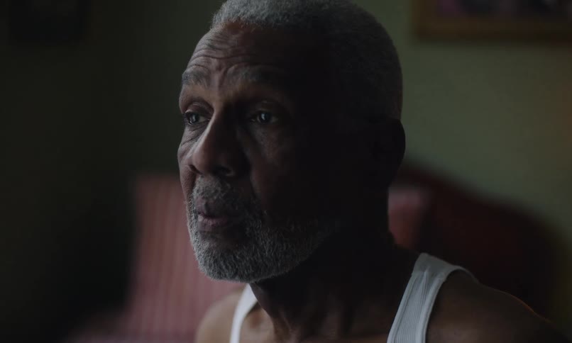 Concerned man blinks while in a bedroom
