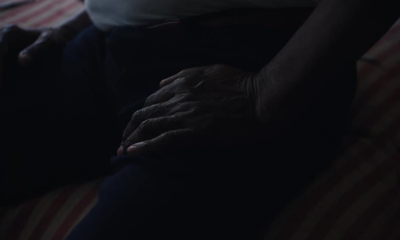 A man is sitting in bed