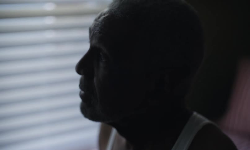 A man is standing by the window