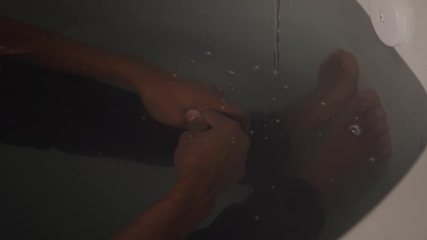 Body of a man in the shower
