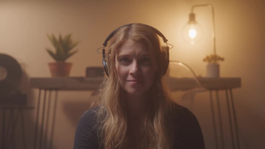 A footage of a lady putting on a headset
