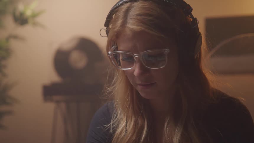 Girl playing piano hearing the sound from headphones