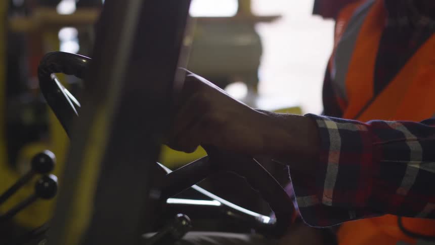A man is driving a forklift