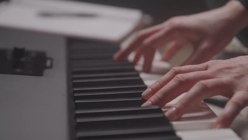 Hands playing the piano