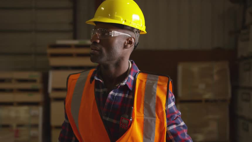 Male worker walks through a lumber warehouse