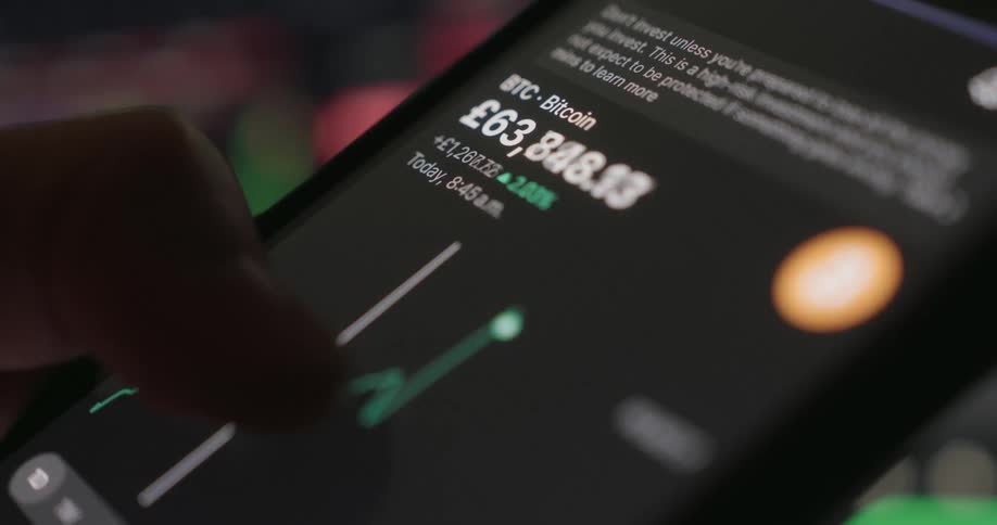 A cryptocurrency graph is on the cell phone