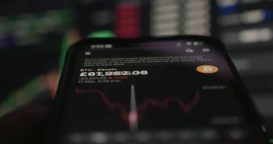 The screen on the phone shows a cryptocurrency