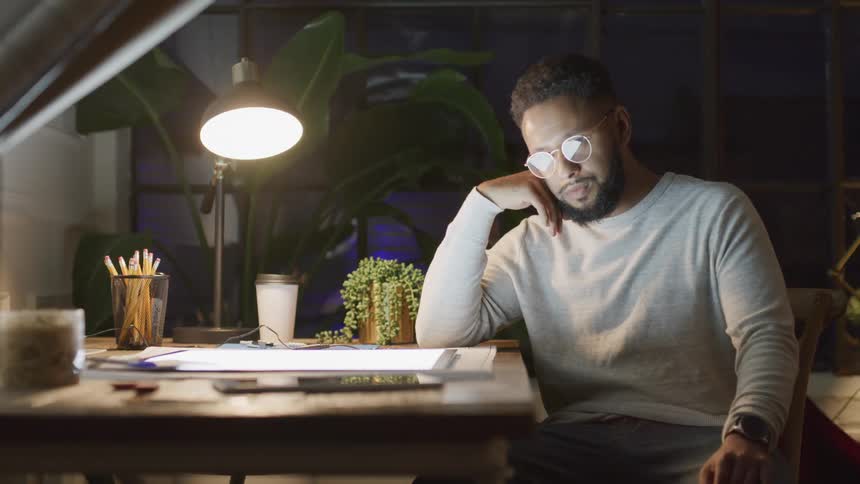 A man is thinking at his desk