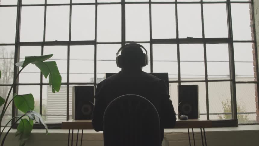 A man is using a computer at the desk